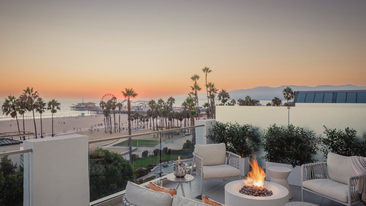 Fire pit, palm trees, and the Pacific Ocean at Regent Santa Monica Beach