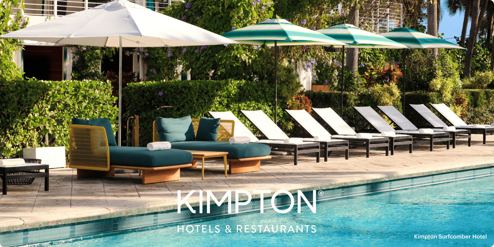 swimming pool with green and white lounge chairs and umbrellas