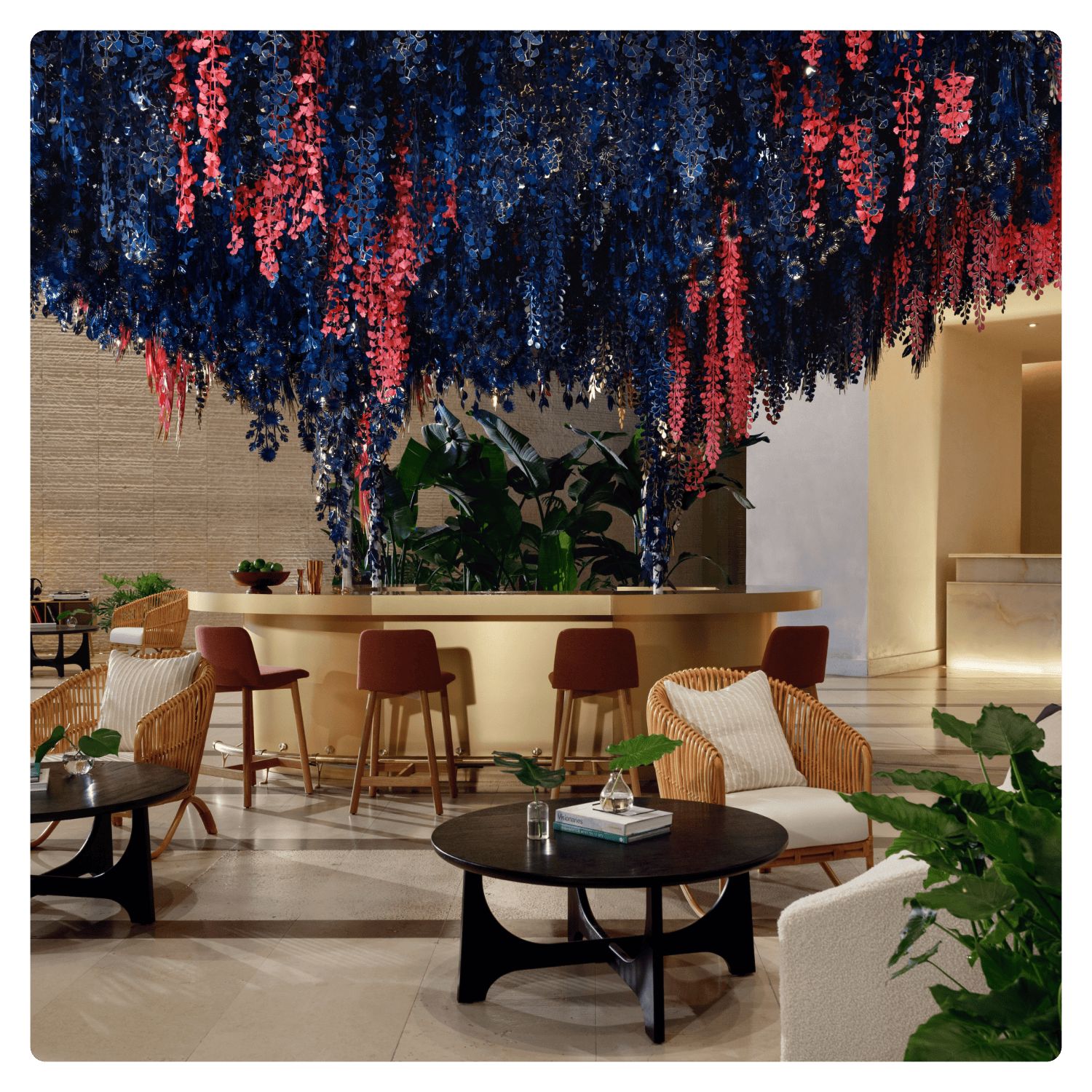 lobby with colorful art installation hanging from the ceiling