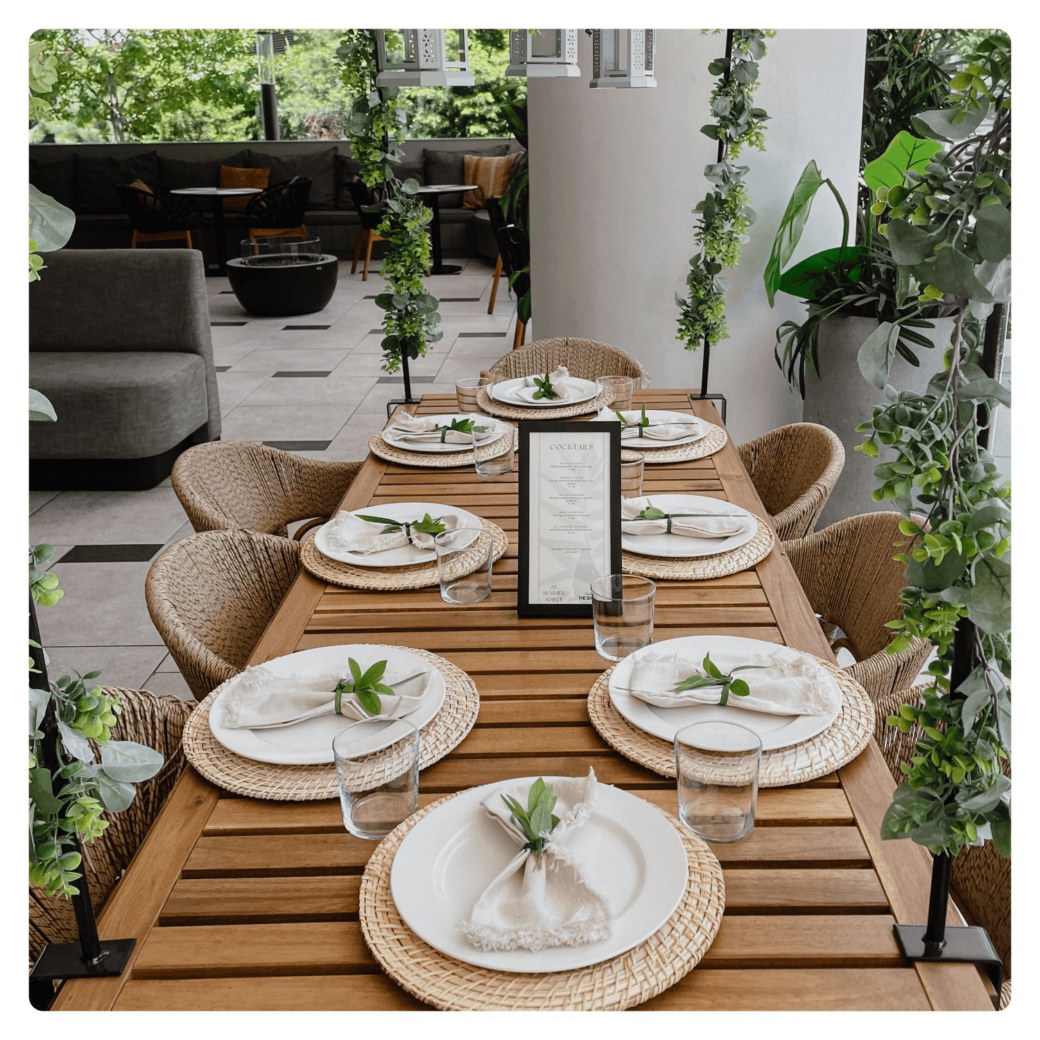 outdoor dining area on wooden table set for a party