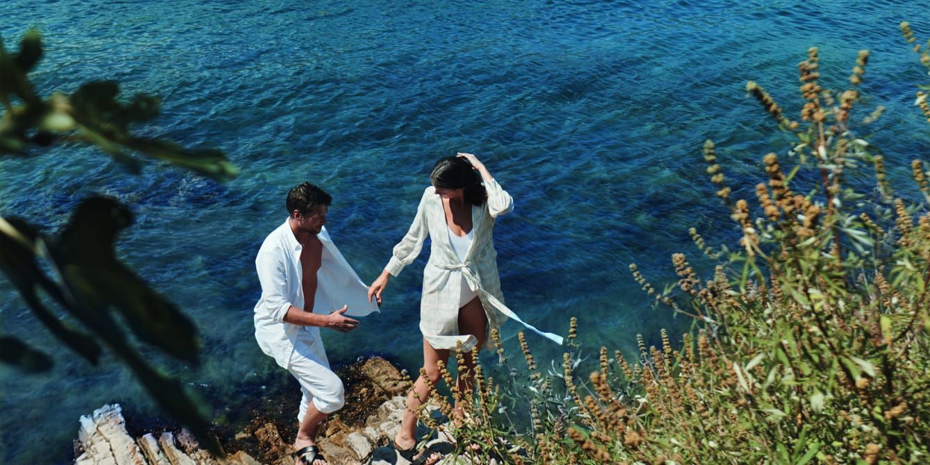 Tropical luxury scene featuring a couple by the ocean