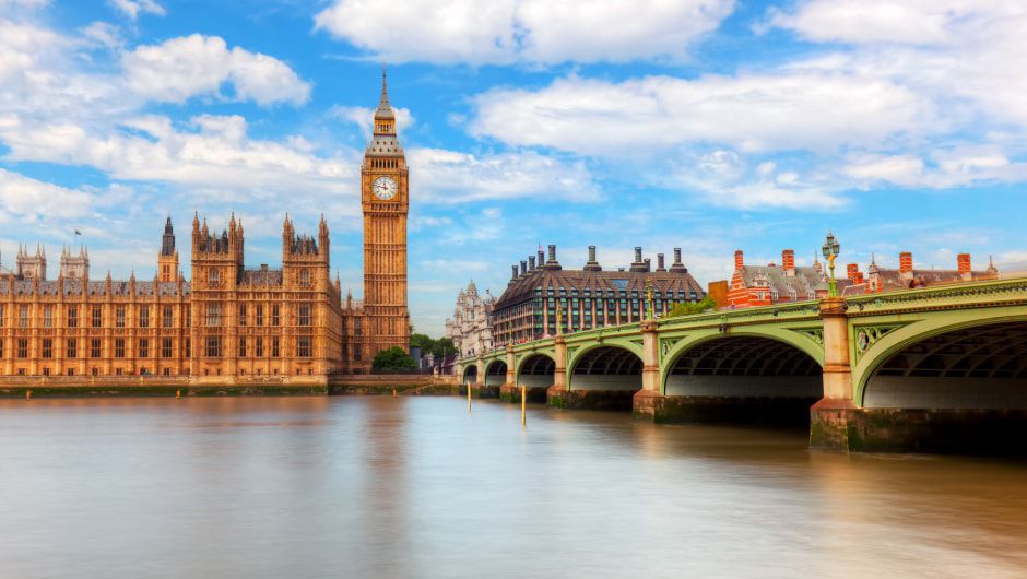Big Ben across a bridge on a sunny day