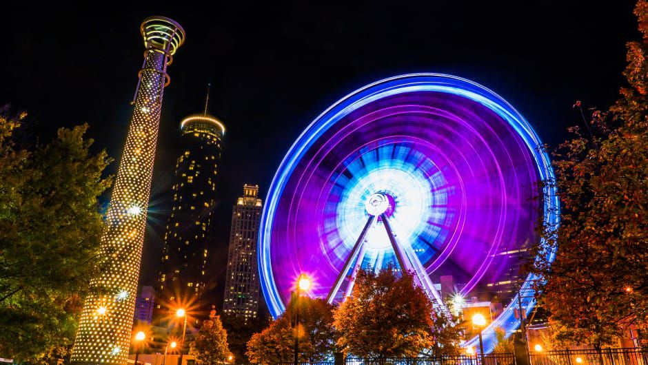 Ferris wheel and buildings lit up at night