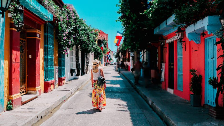 Woman walking down colorful street