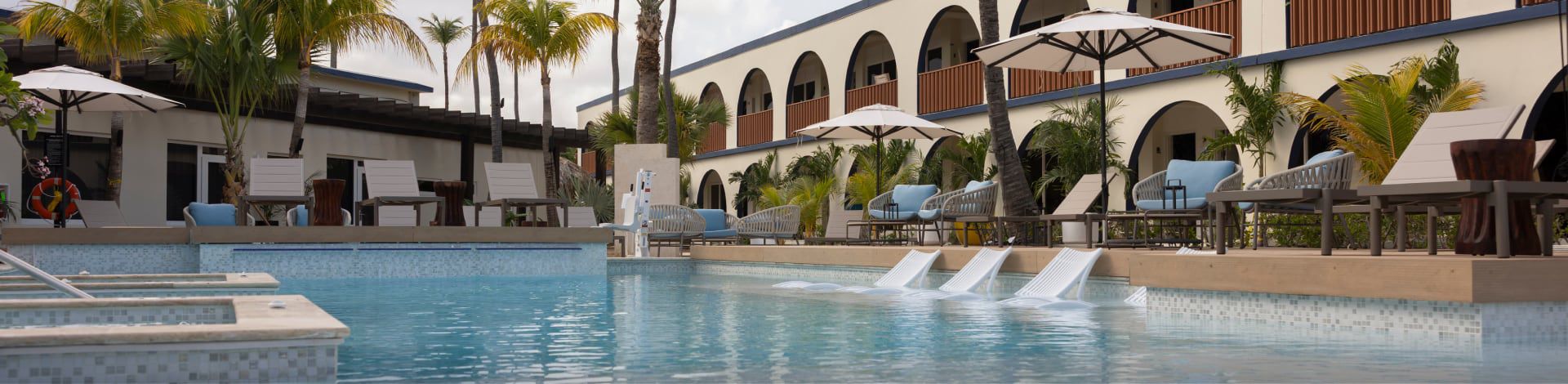 In-pool and poolside lounges at voco Surfside Aruba