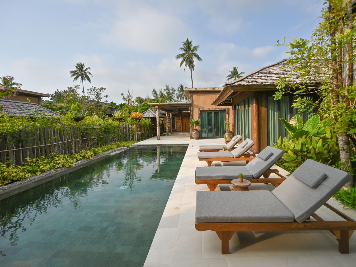 Tropical private pool villa with outdoor loungers