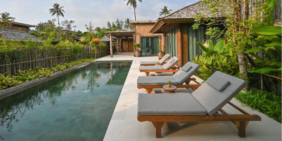 Tropical private pool villa with outdoor loungers