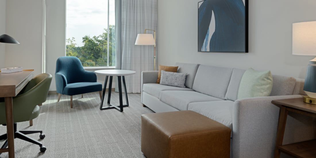 Staybridge Miramar suite with living area and workspace