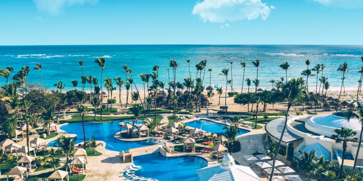 Aerial shot of beachside pools and tall palm trees