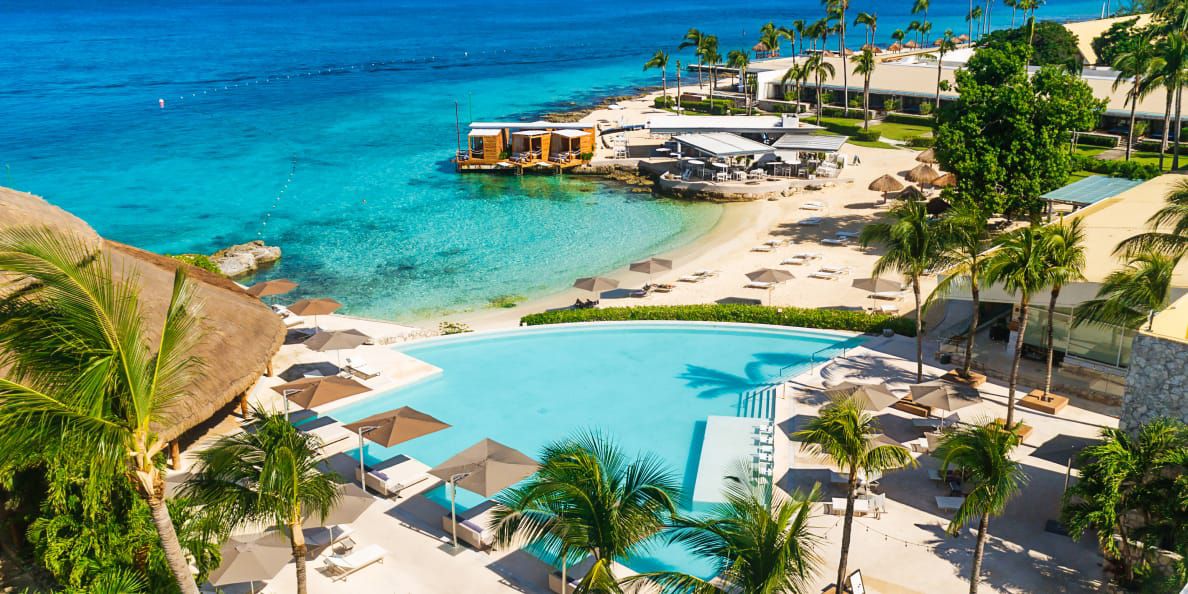 Aerial view of large infinity pool blending into the turquoise ocean
