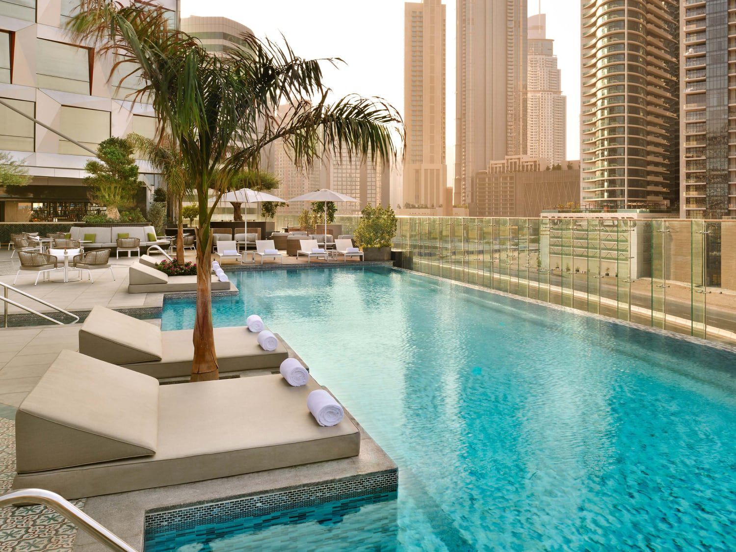 Palm-lined pool at Hotel Indigo Dubai Downtown