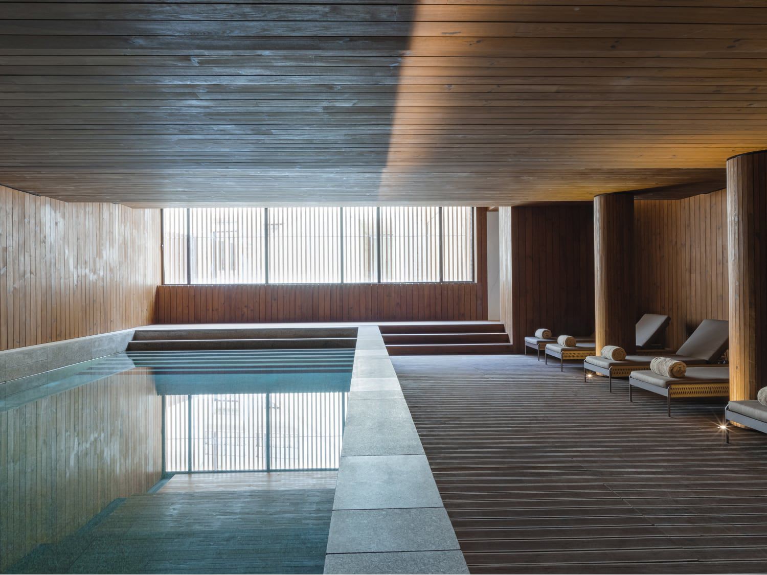 Minimalist, wood-paneled spa pool at Casa da Companhia Hotel & Spa, Vignette Collection