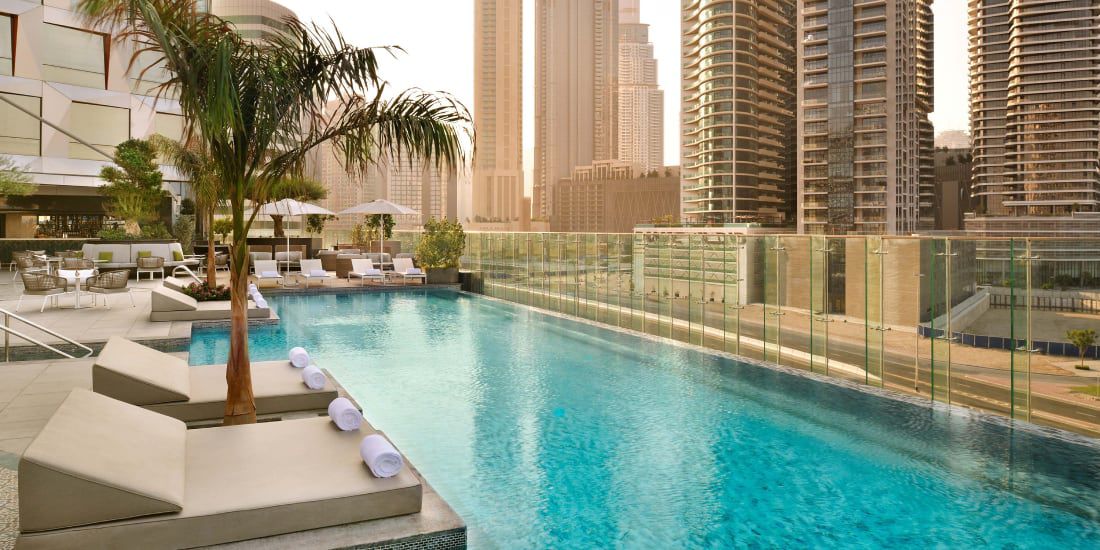 Palm-lined pool at Hotel Indigo Dubai Downtown