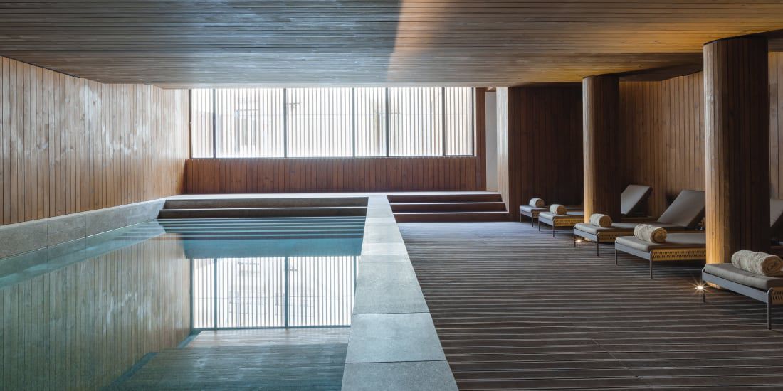 Minimalist, wood-paneled spa pool at Casa da Companhia Hotel & Spa, Vignette Collection