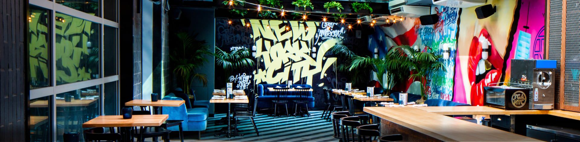 Vibrantly colored bar and dining area featuring graffiti art