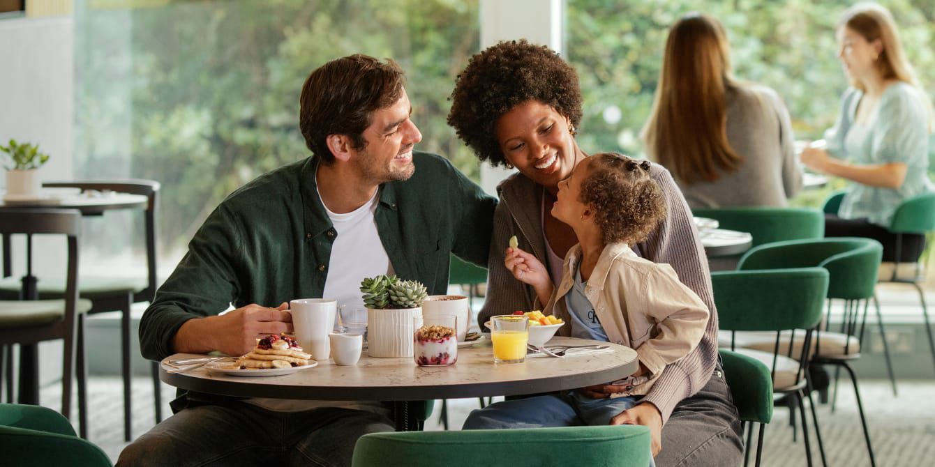 Family sat eating breakfast at a Holiday Inn