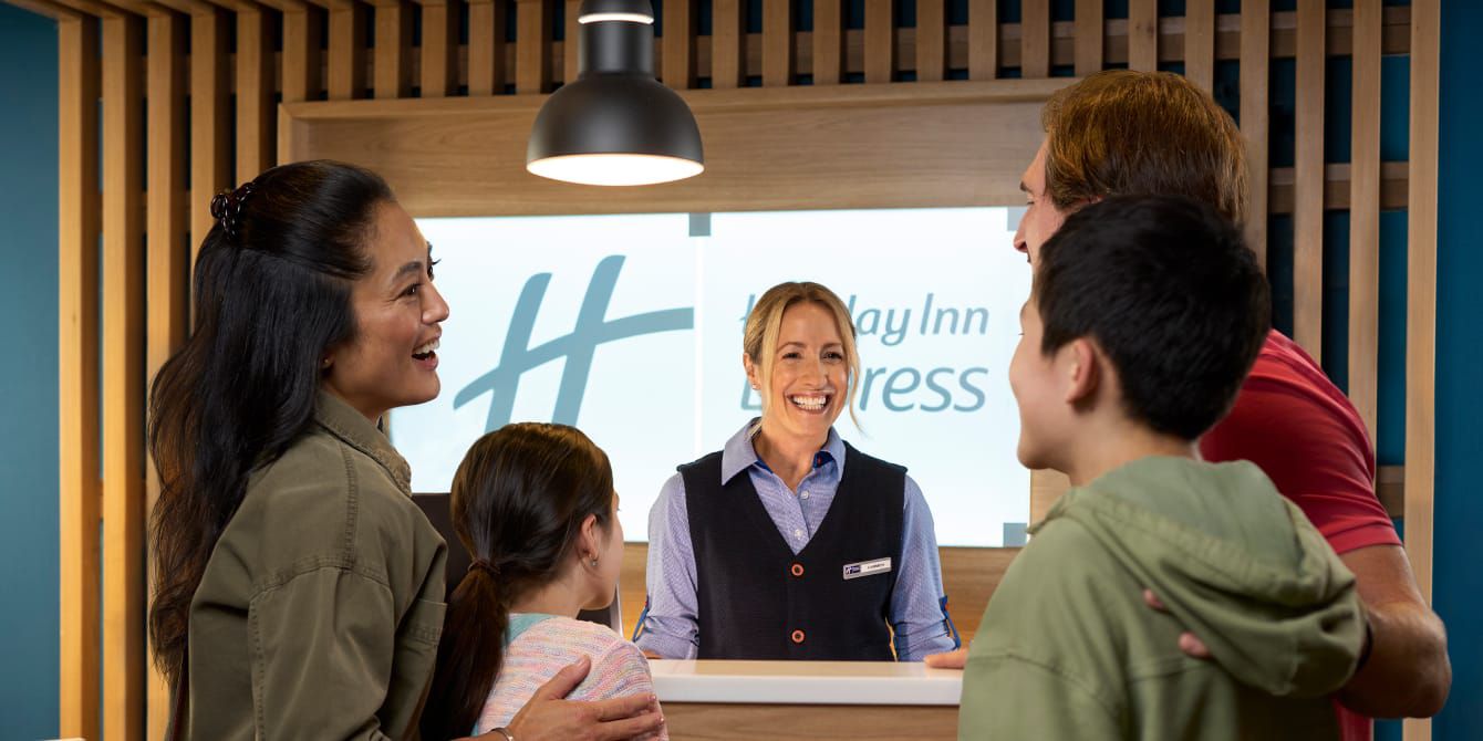 Holiday Inn Express reception with family checking in