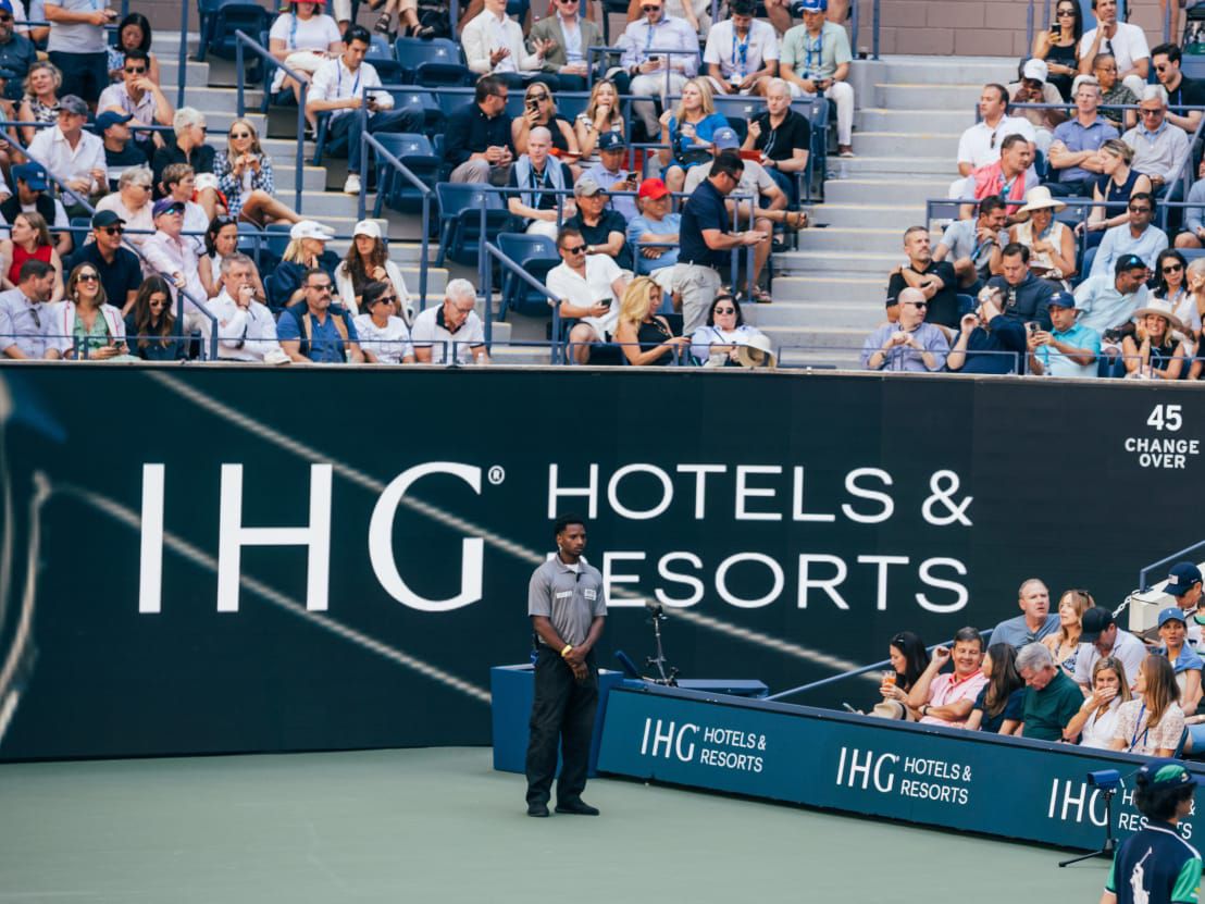 IHG Hotels & Resorts logo wrapping the tennis stadium.