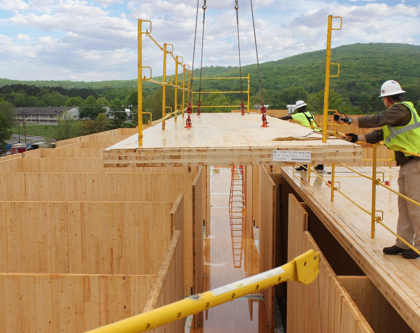 Construction site with trees and blue skies in the background.