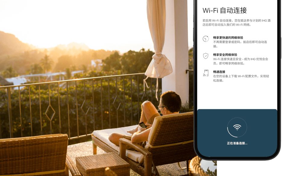 Man lounging on balcony using phone, IHG app wi-fi auto connect on phone screen