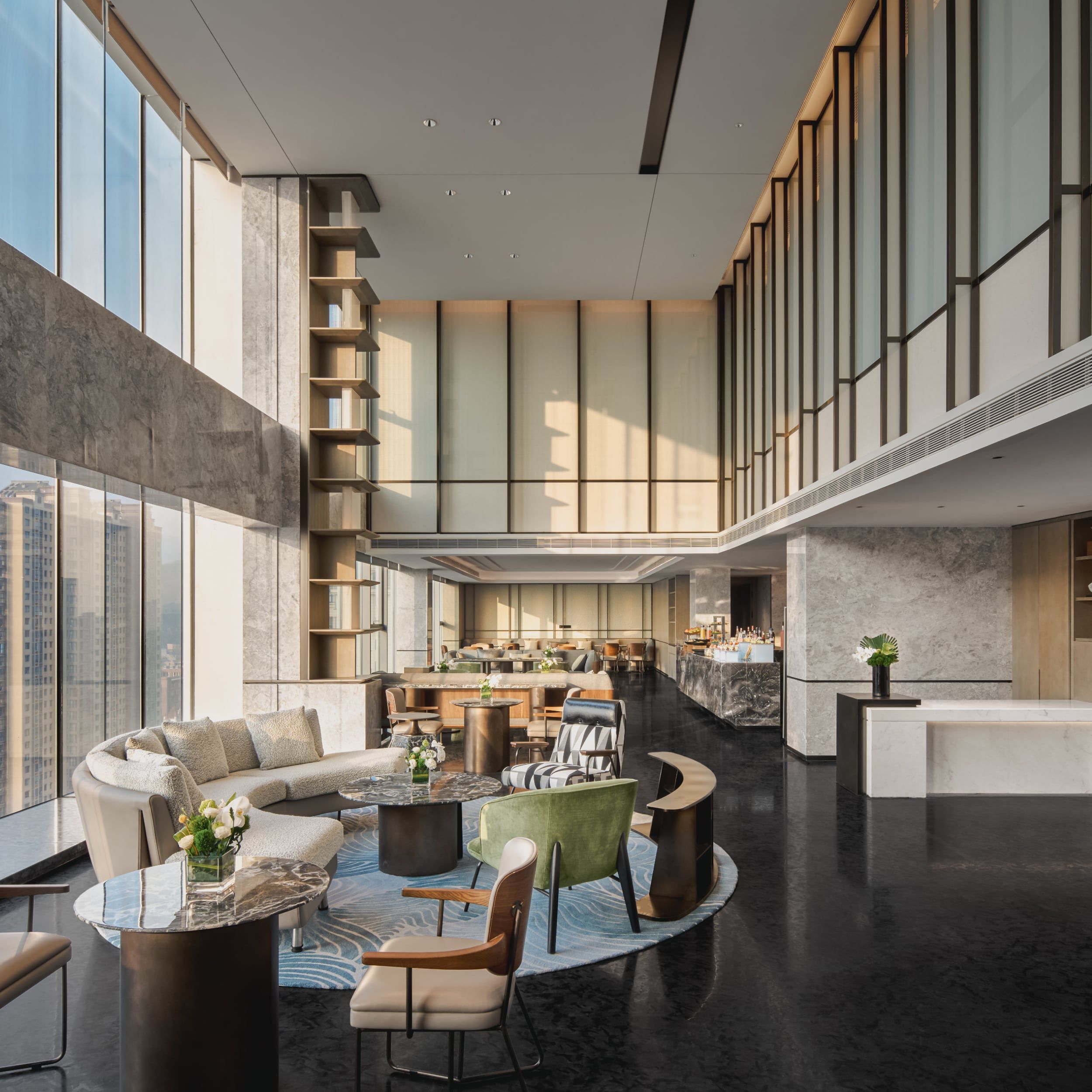 Chase IHG One Rewards credit cards overlaying a luxurious modern hotel lounge with floor-to-ceiling city views.