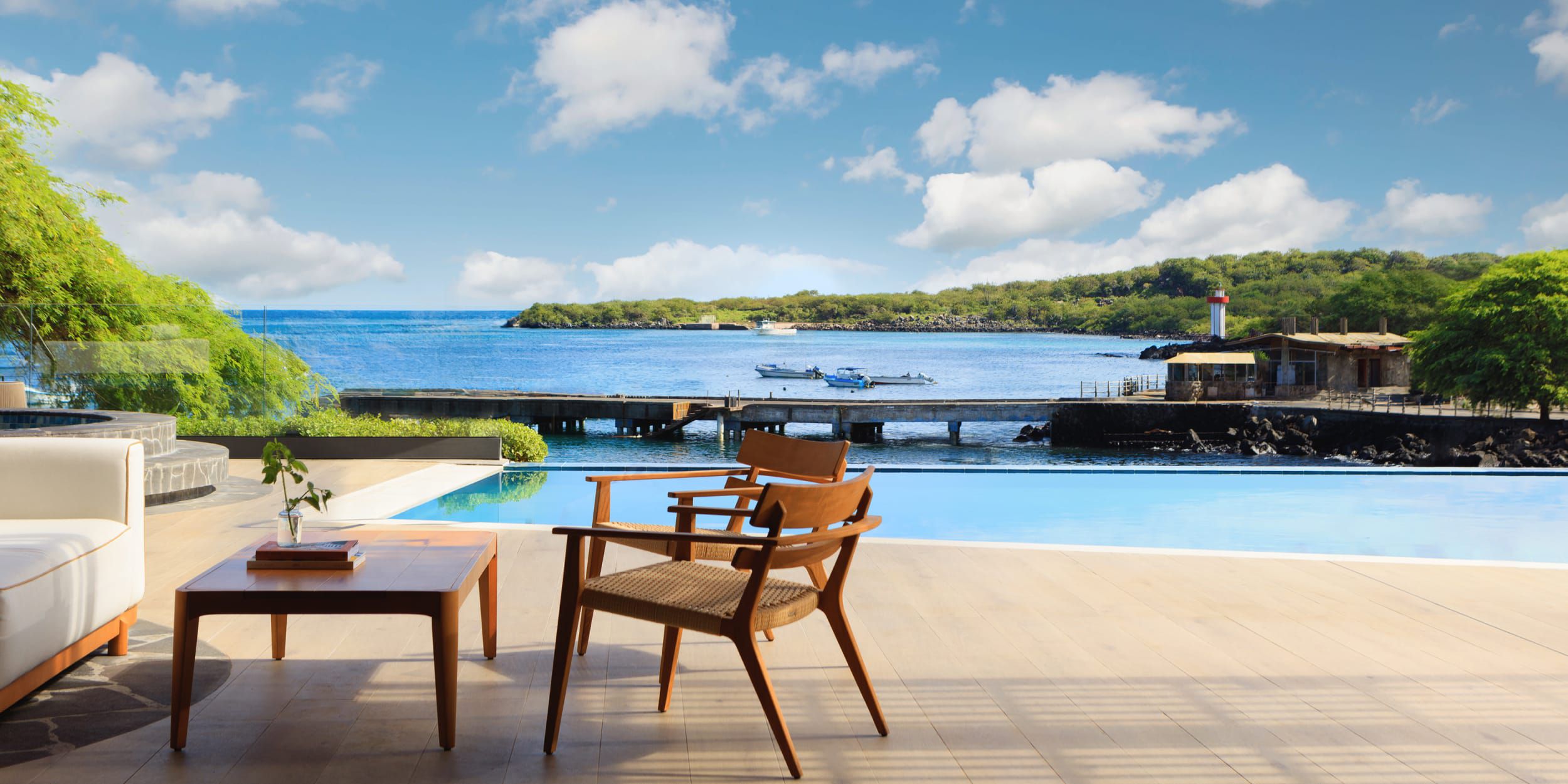 Private terrace with lounge chair, dining table, infinity pool and ocean views.