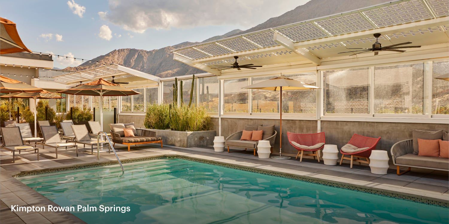 Swimming pool with lounge seating surrounded by mountains