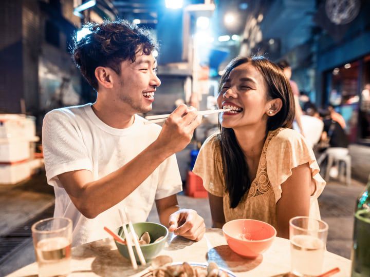 Young couple enjoying a local meal