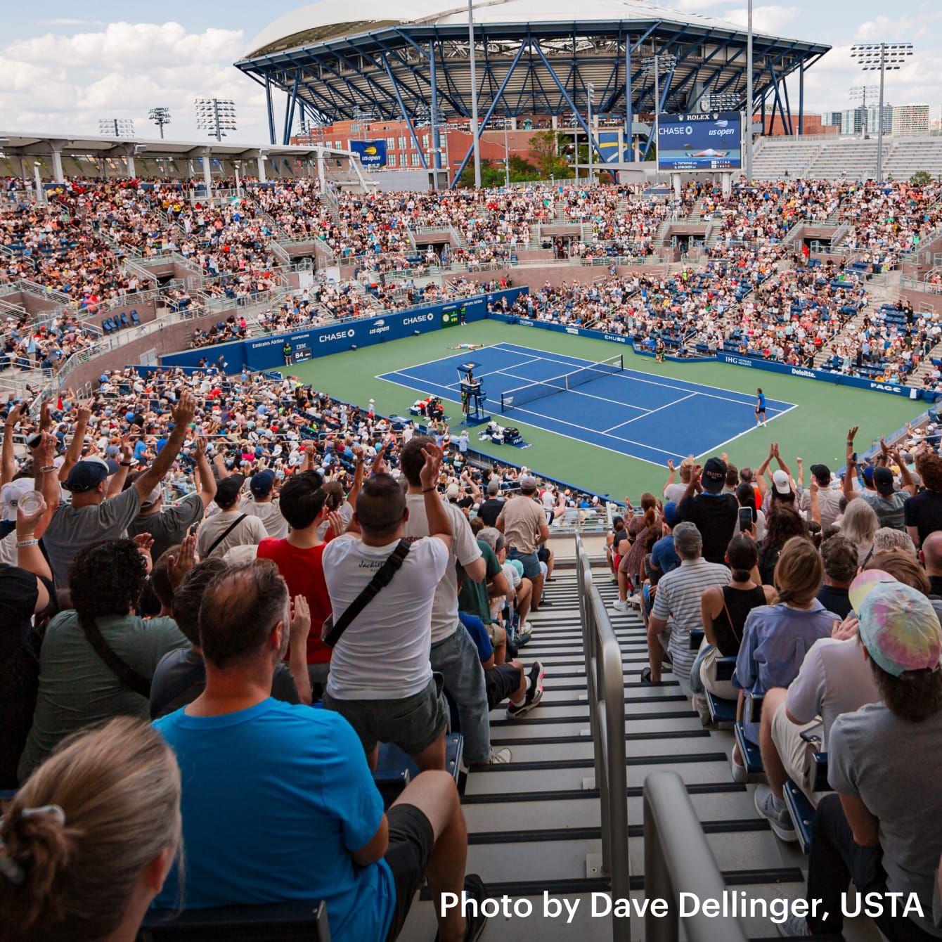 Image of tennis court from crowd