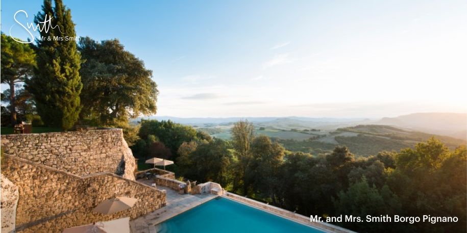 A stunning view from the Mr &amp; Mrs Smith Borgo Pignano featuring the hotel’s pool against a jaw-dropping Tuscan background.