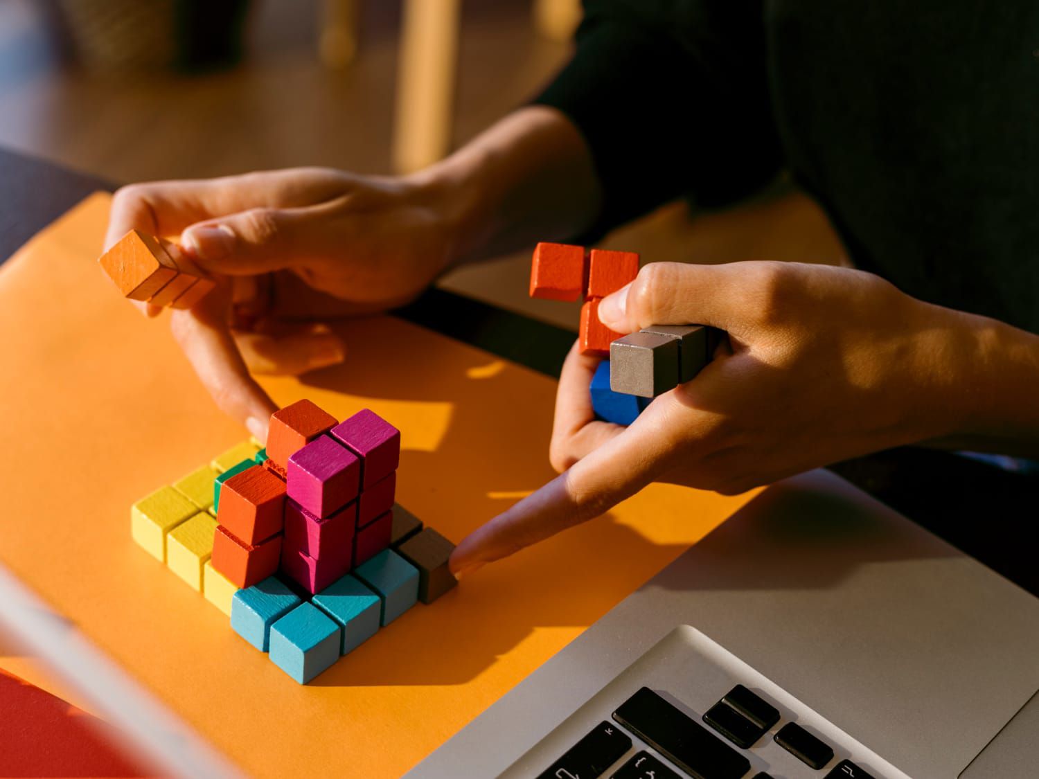 Hands playing with colorful fidget puzzle