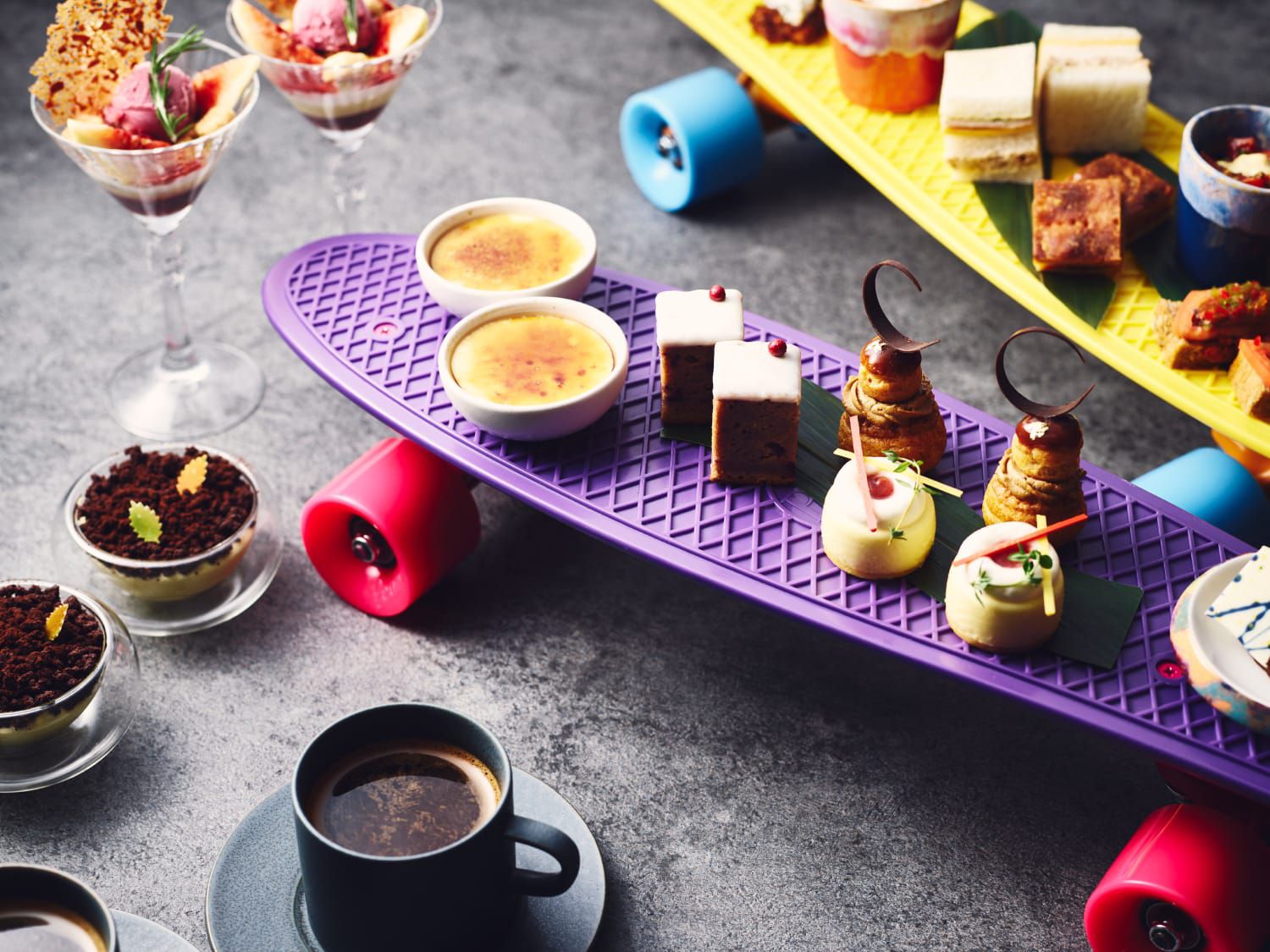 Fancy small bites of colorfully plated food on skateboards