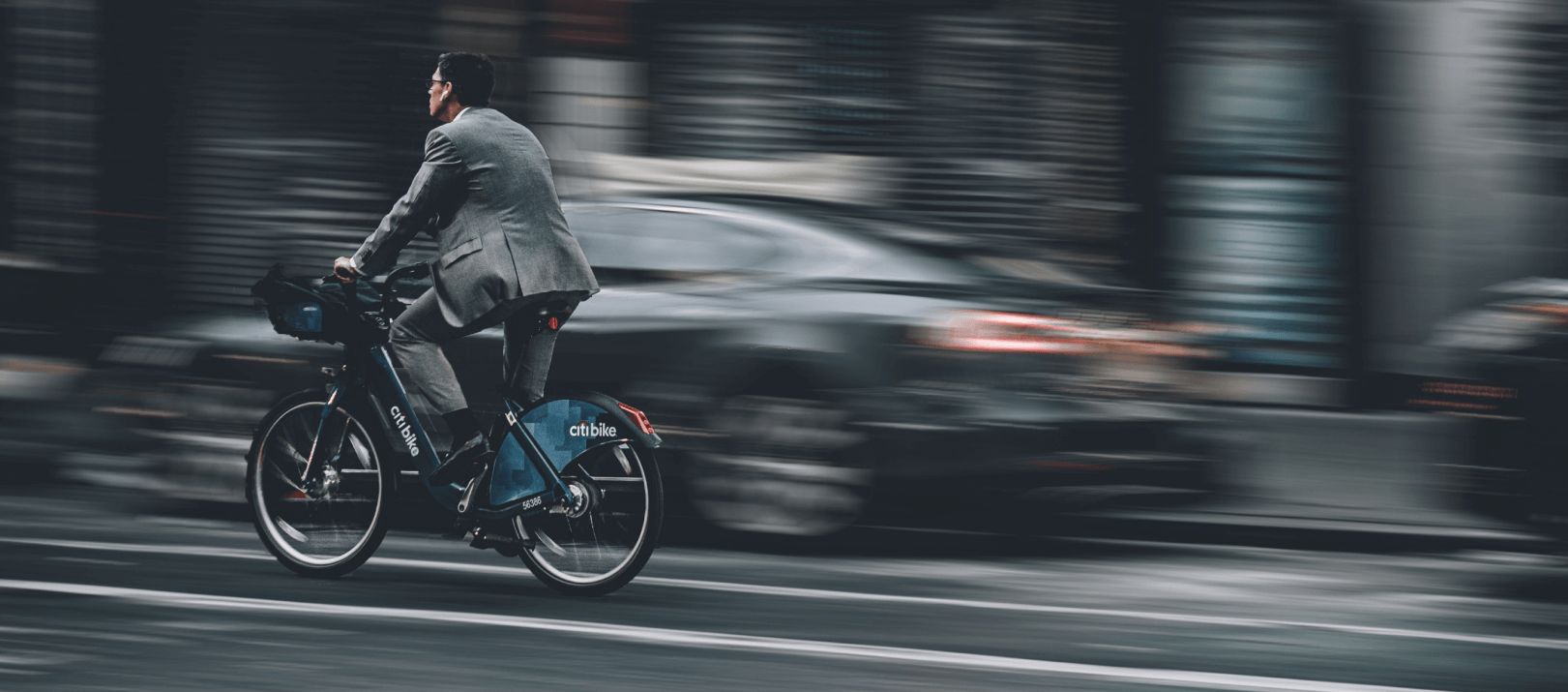 Man in a suit on a bicycle