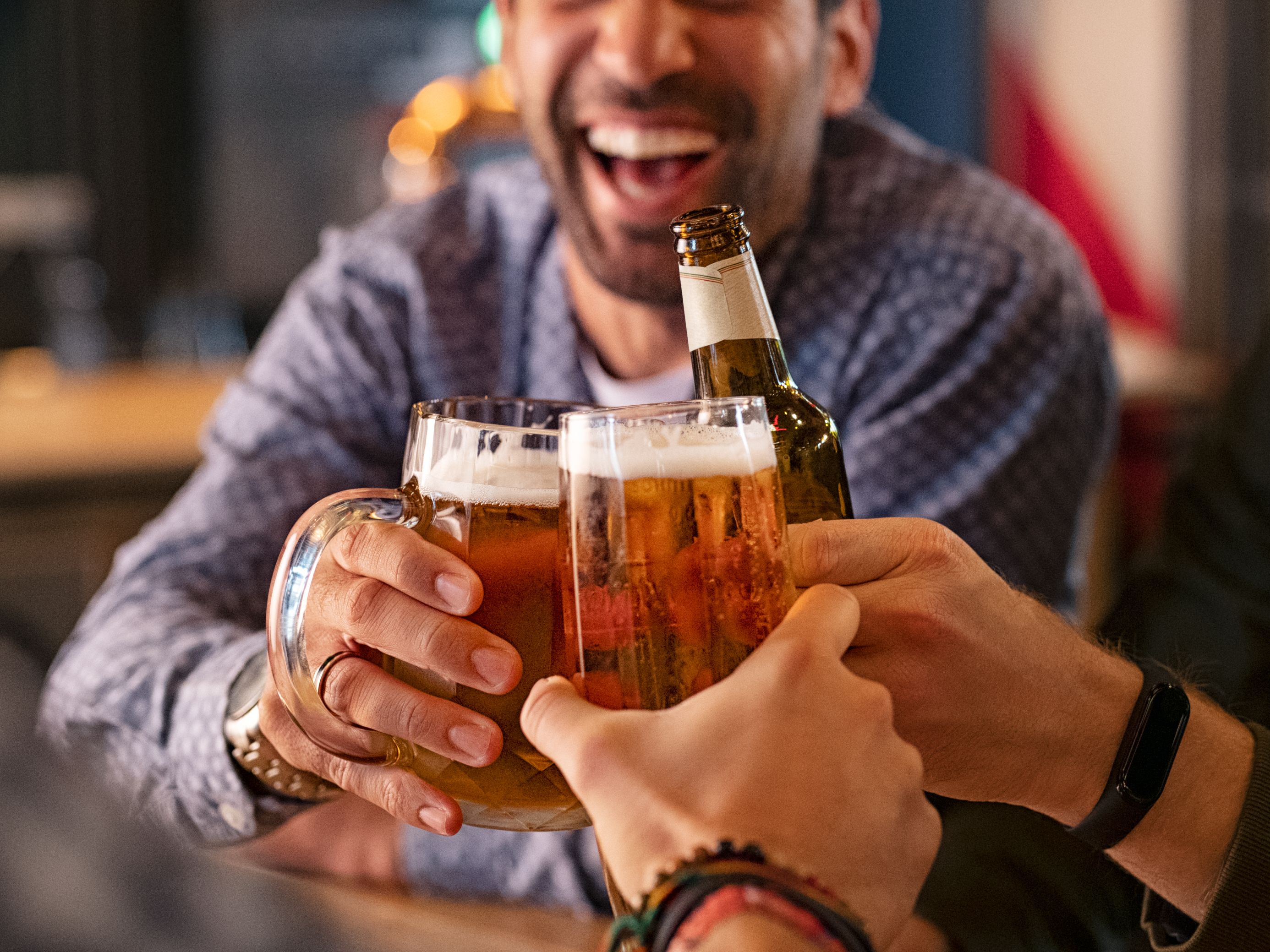 Group of friends toasting with beer