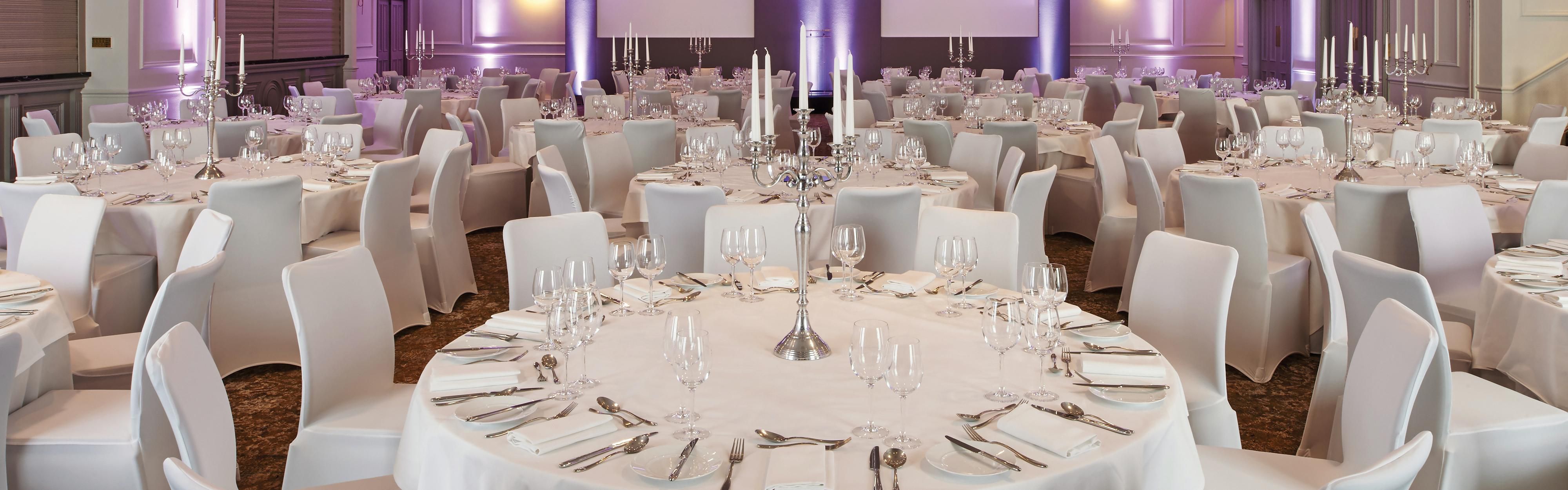 All white conference room with tables and chairs