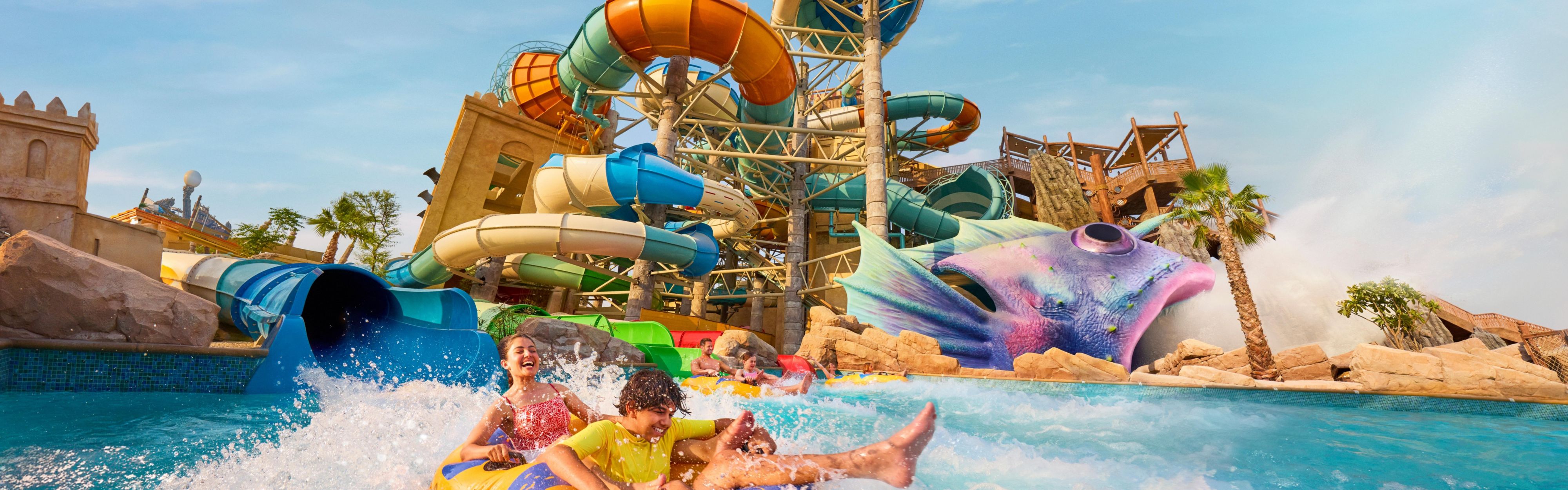 Yas Plaza Bay guests enjoying Yas WaterWorld slides and rides