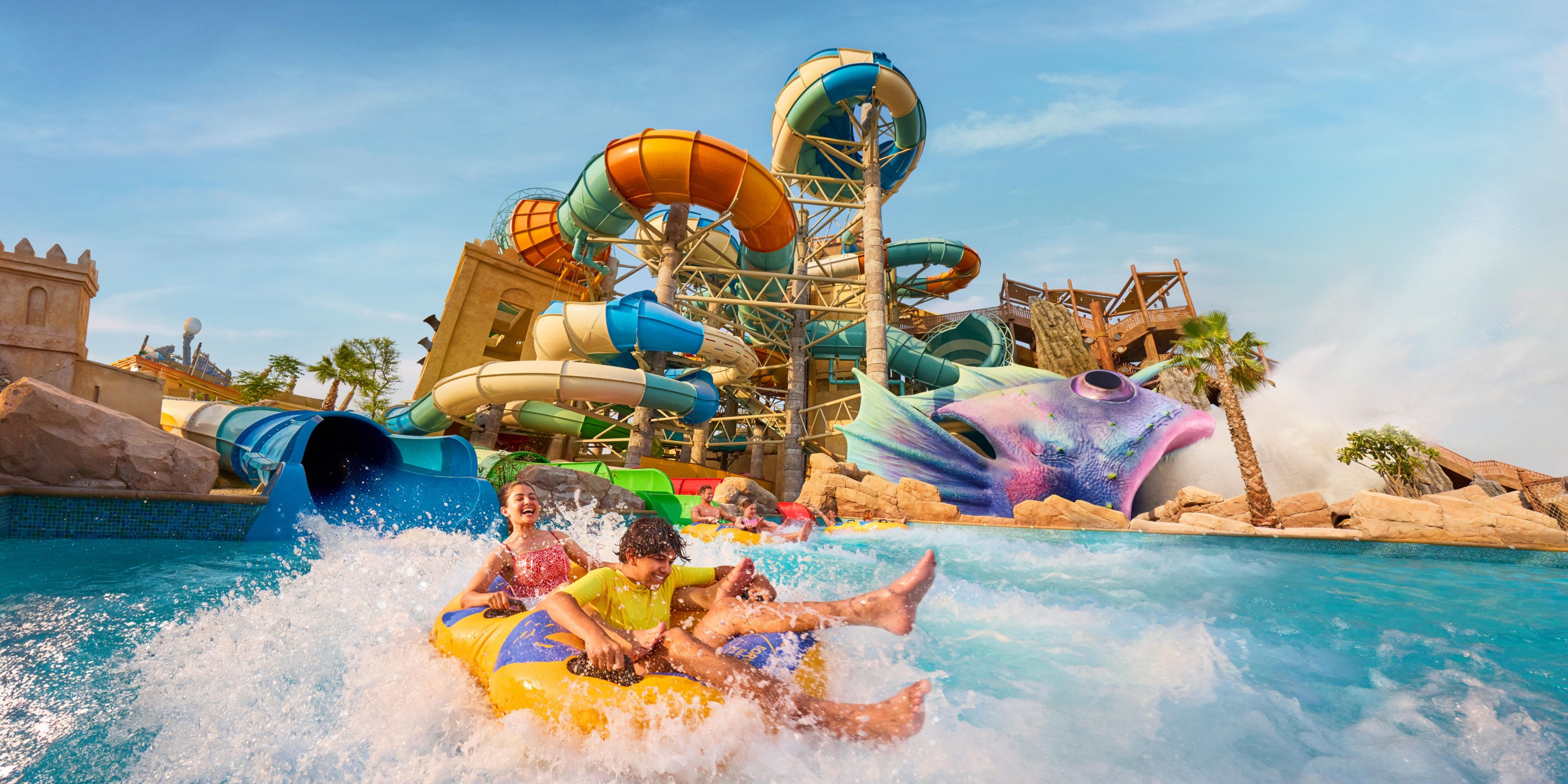 Yas Plaza Bay guests enjoying Yas WaterWorld slides and rides