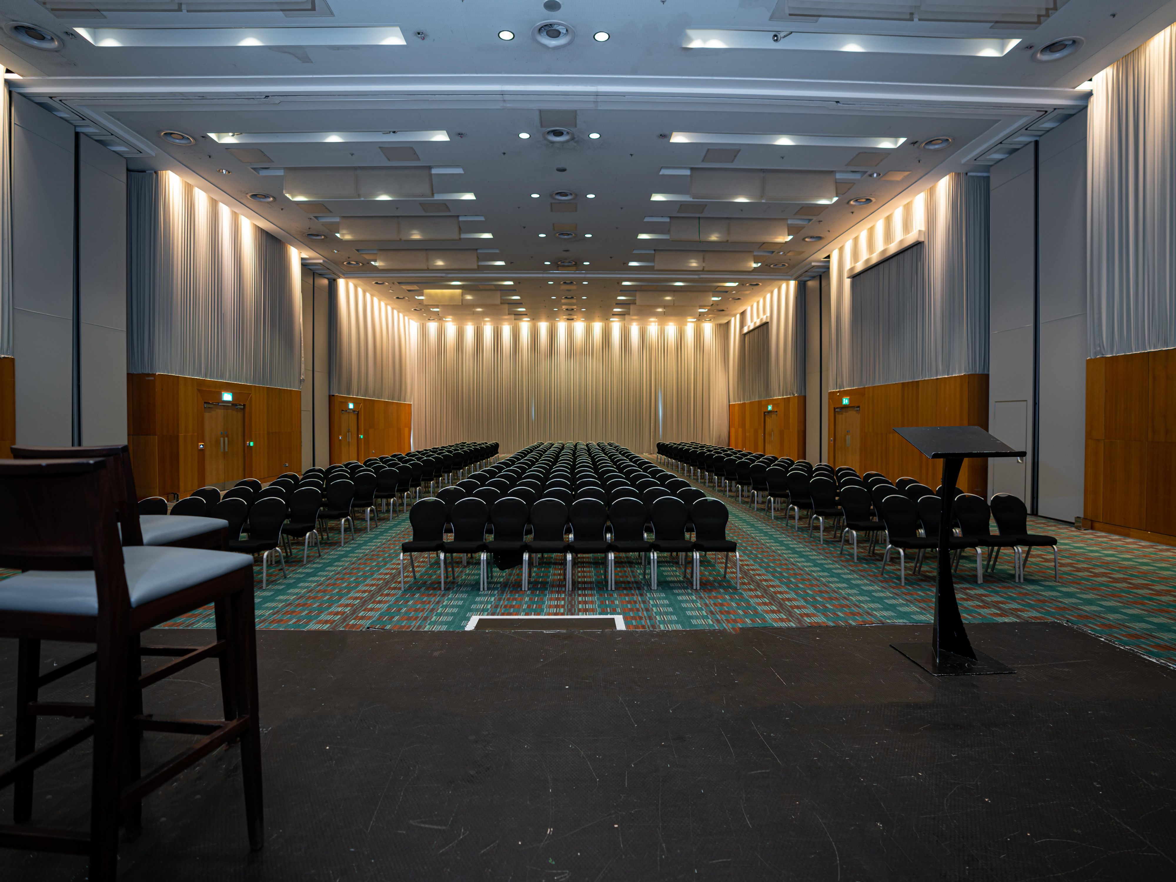 Large events venue with stage and many chairs