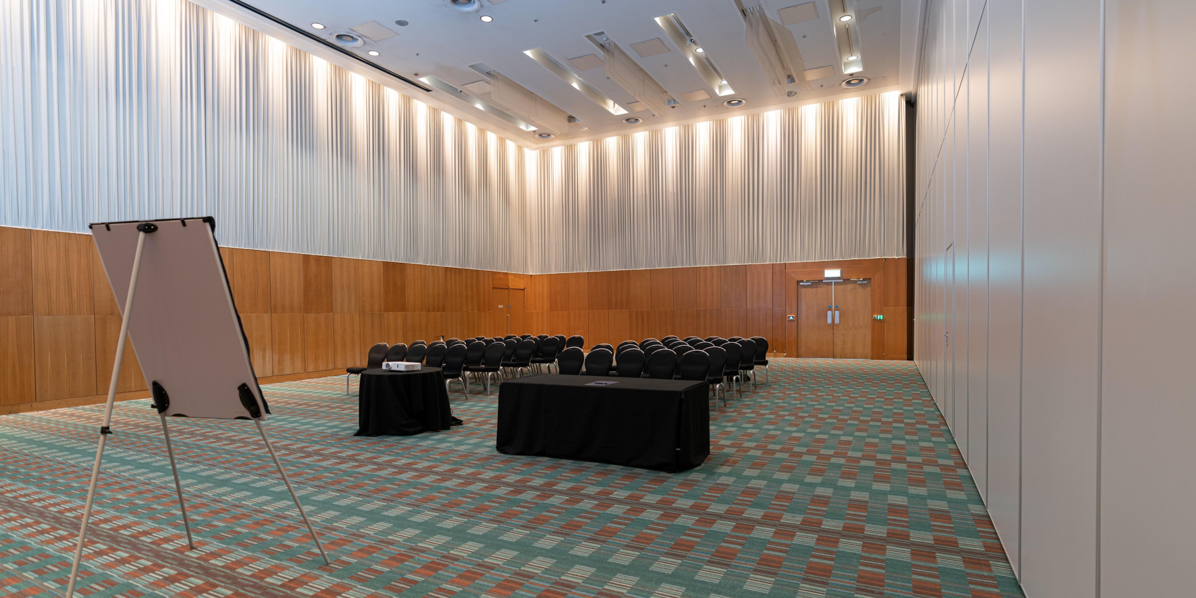 Large conference room area with added office supplies such as a flipchart