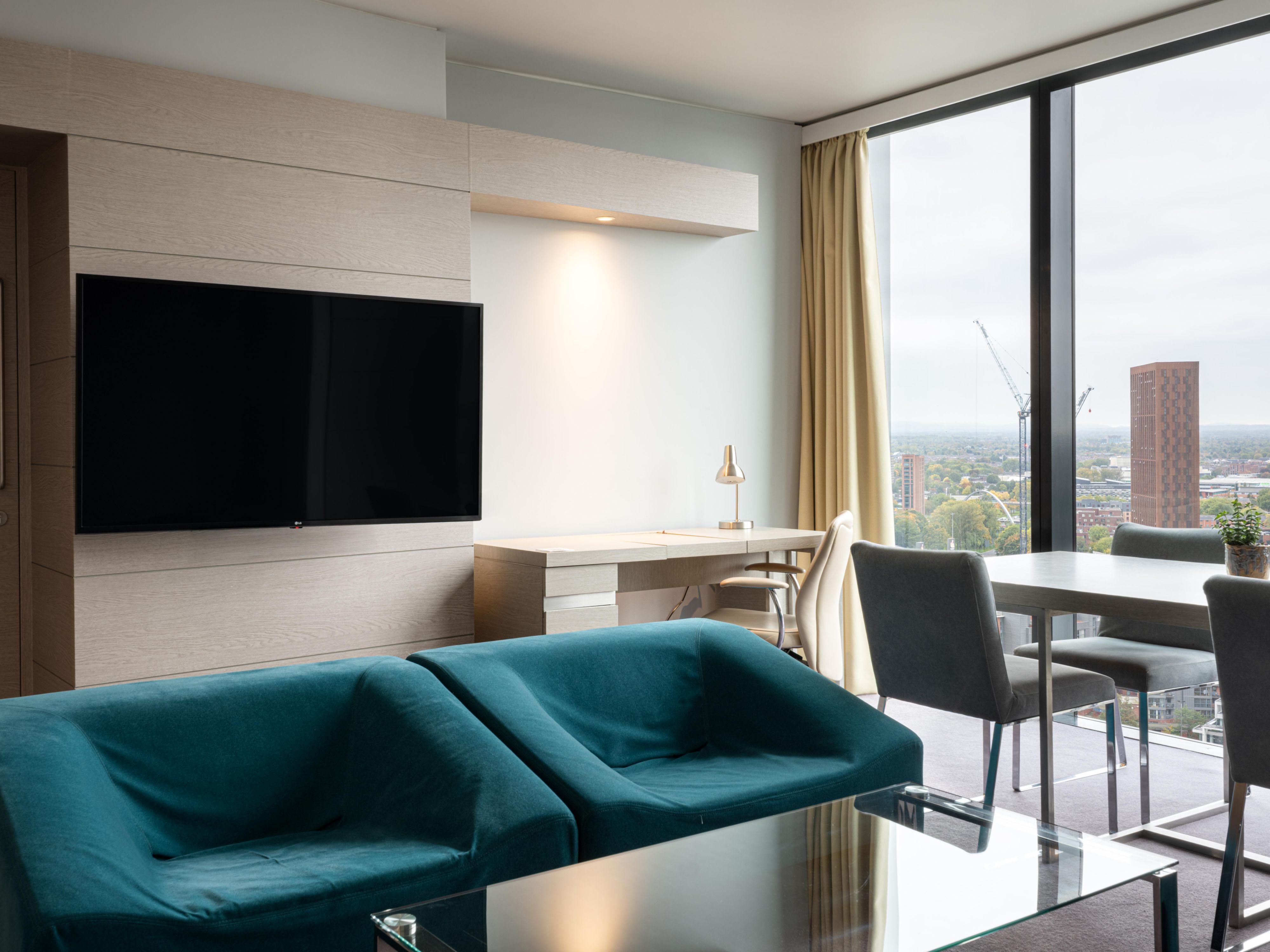 comfy seating area with a television in one bedroom suite