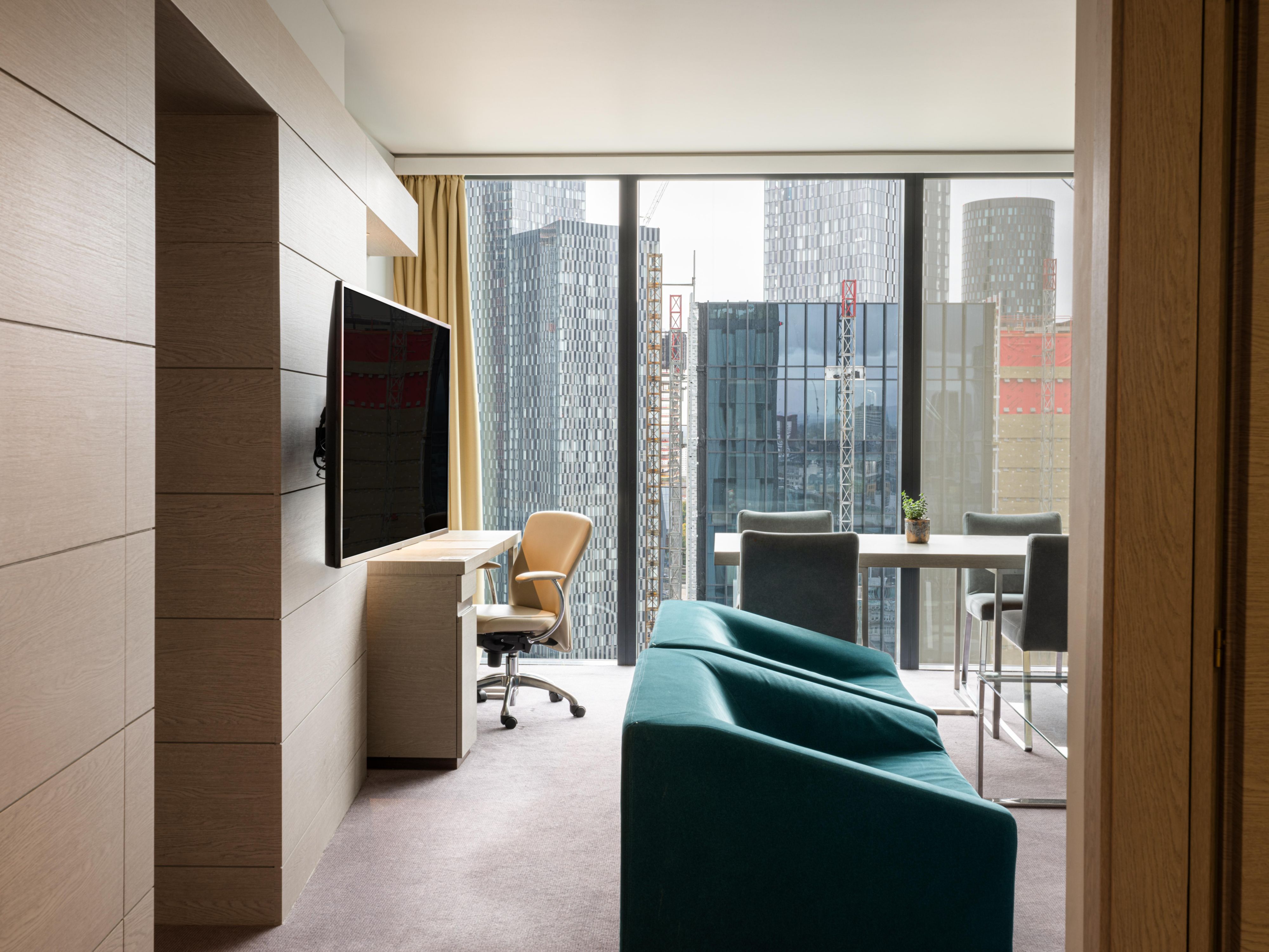 one bedroom suite with lounge area and city views