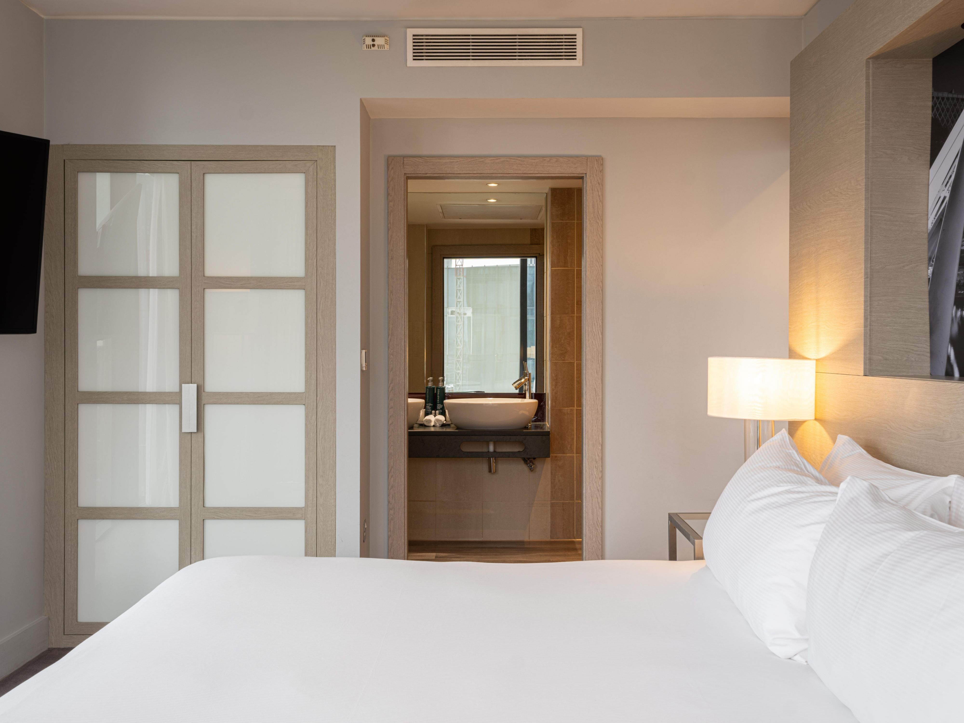 hotel guest suite with a wardrobe and en-suite bathroom