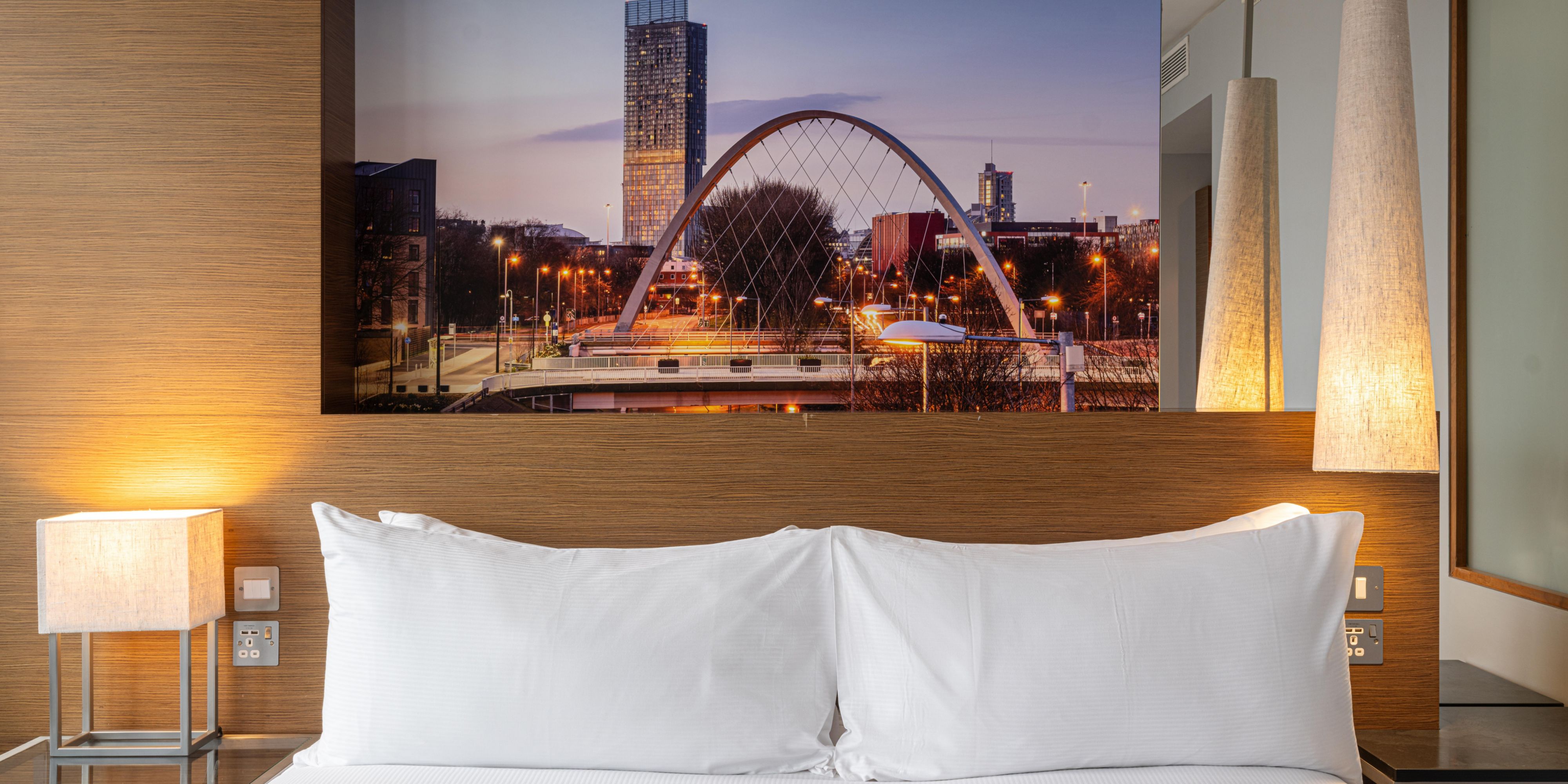 Cosy hotel guest room with king bed and city views