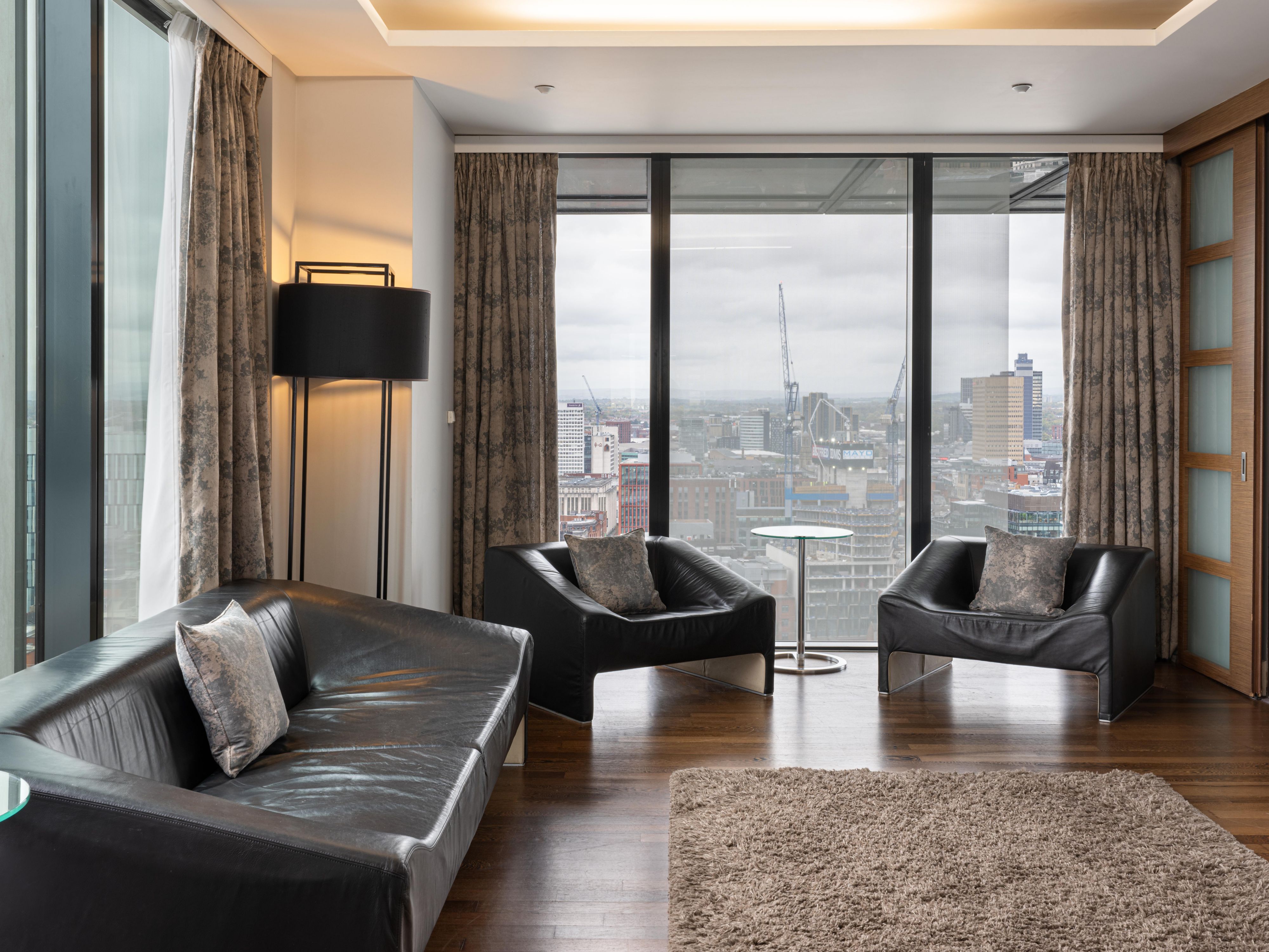 Lounge area in a premium suite in manchester with skyline views