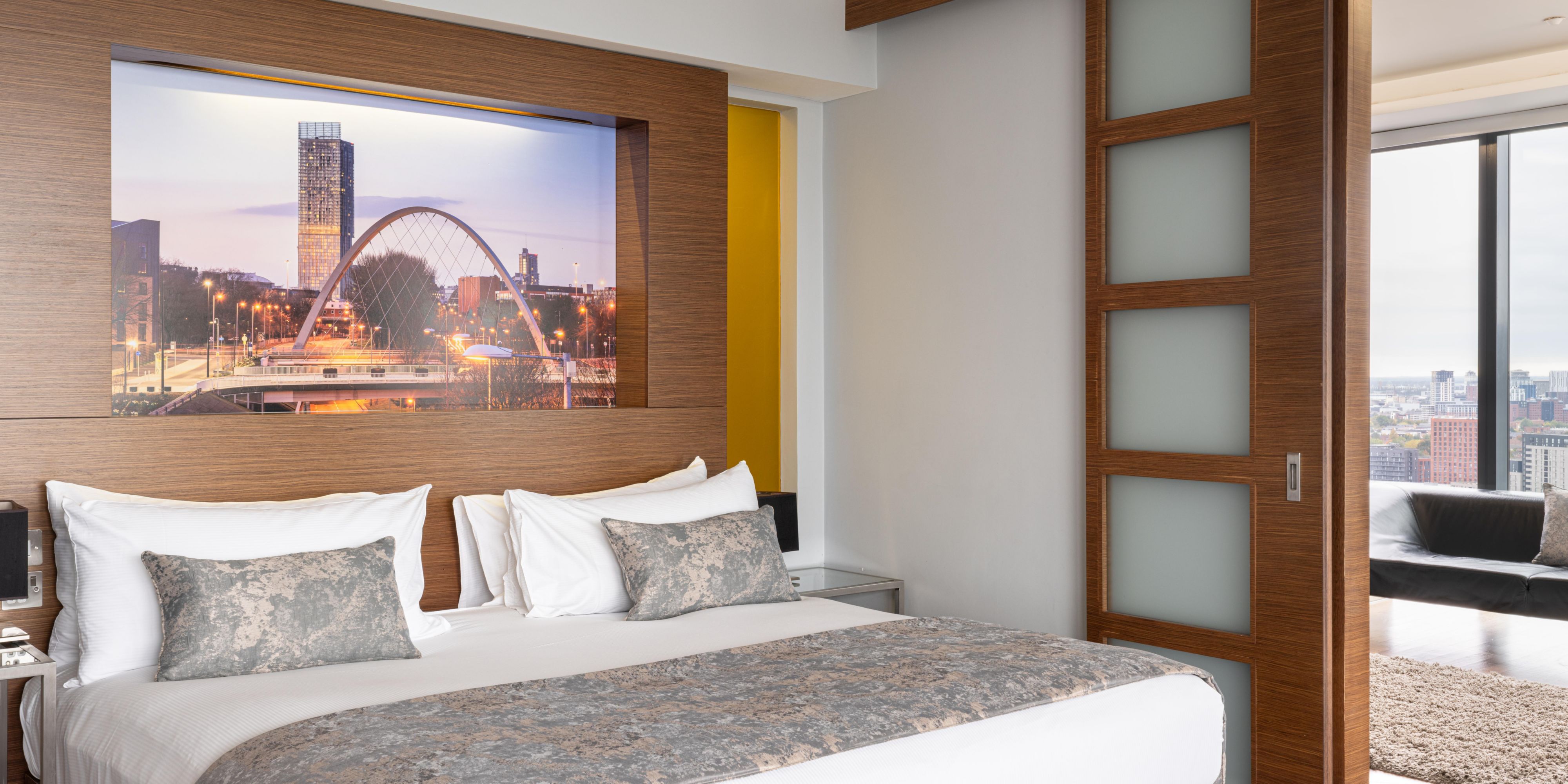 Presidential Suite Master Bedroom with city skyline views and wooden interiors