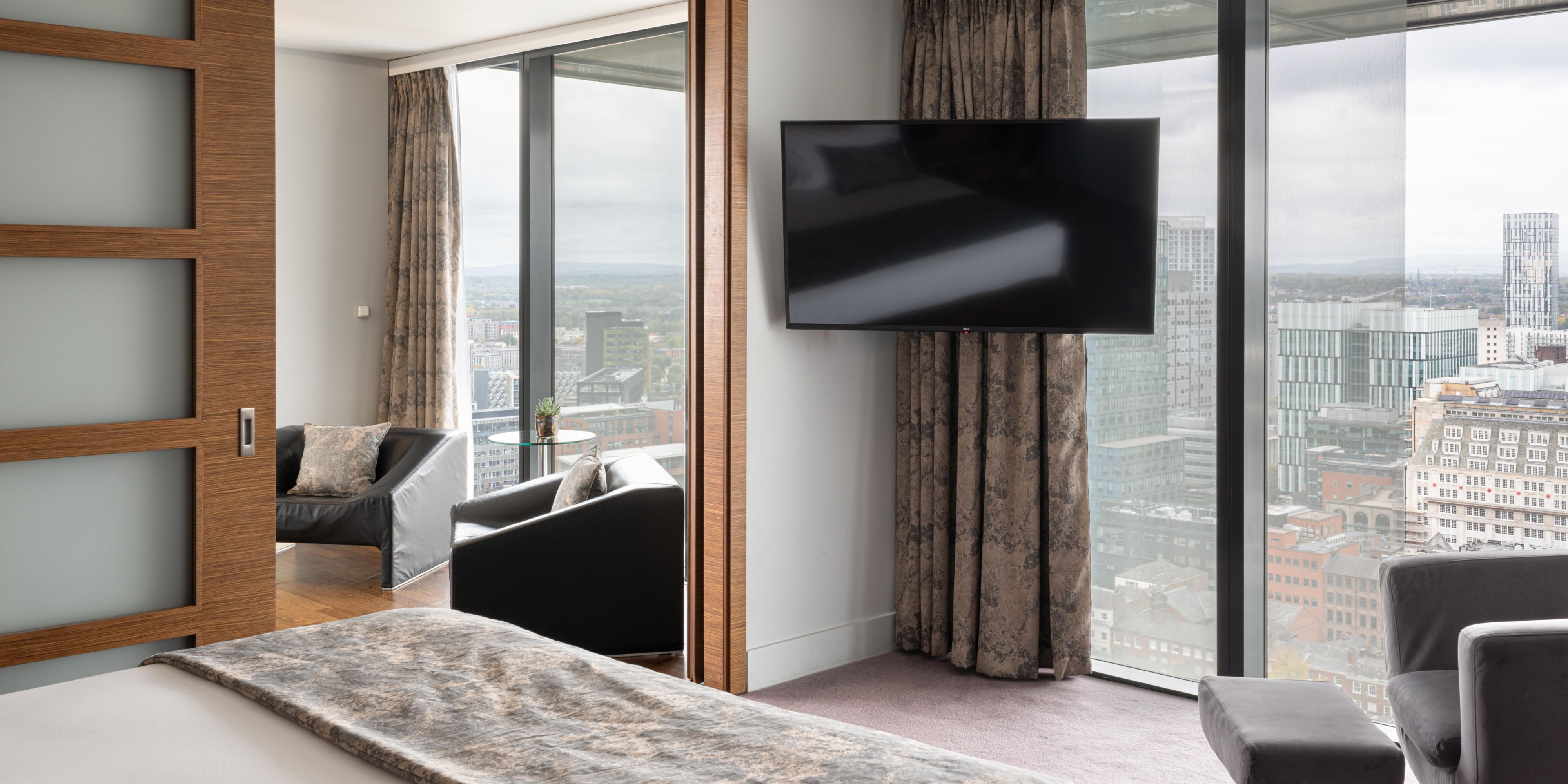 Hotel guest suite with skyline views and lounge area