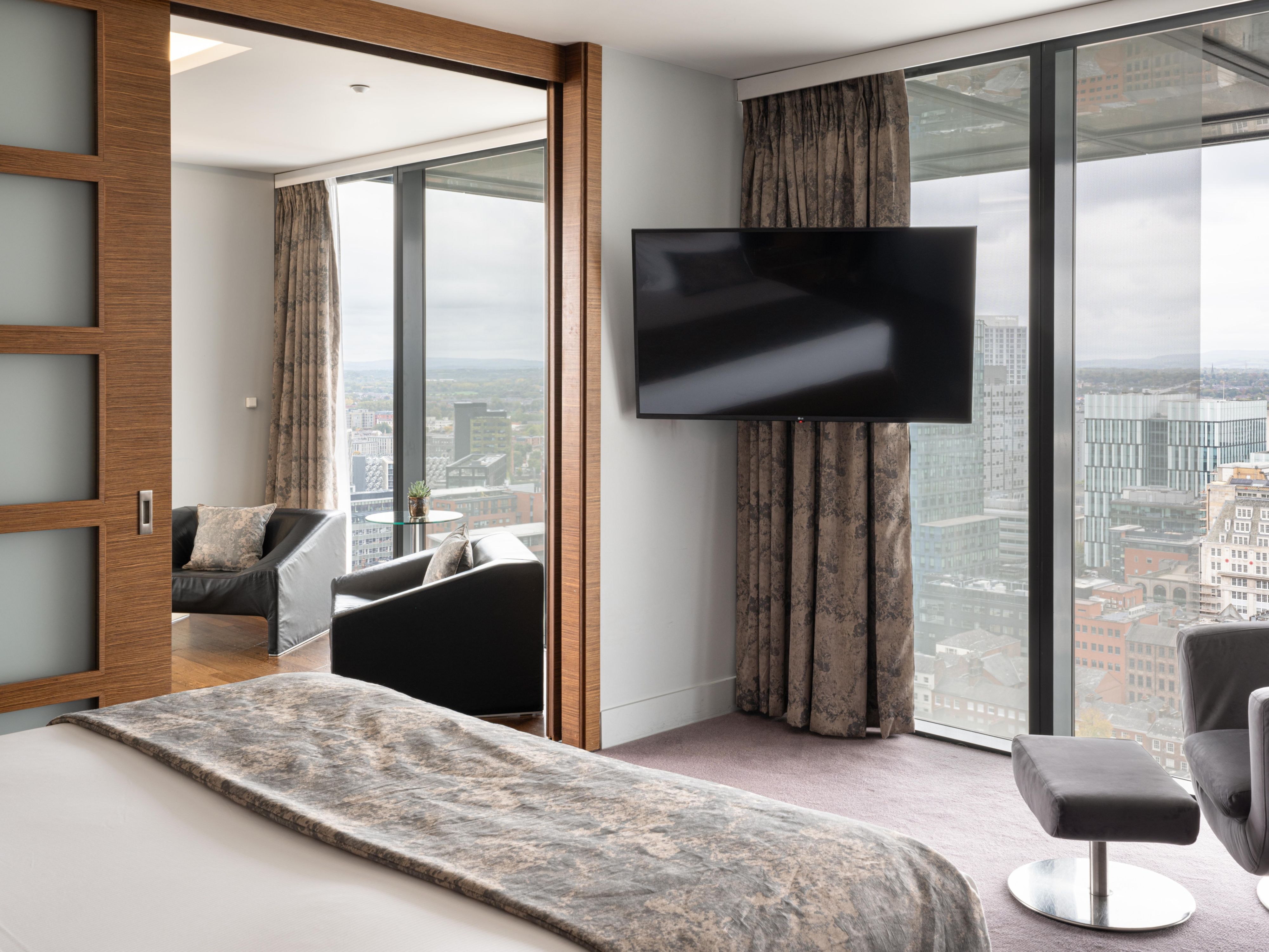 comfy seating and a TV in a premium suite in Manchester with skyline views