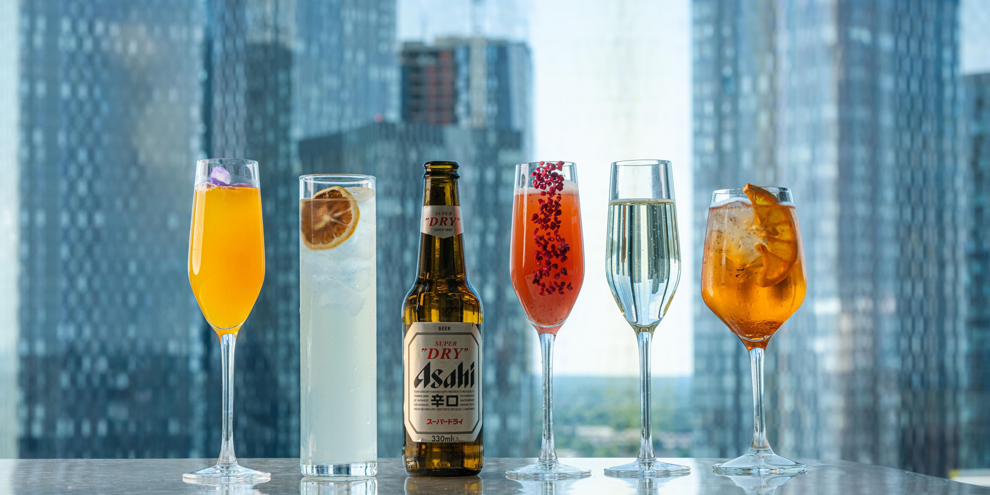 drinks lined up on the bar with manchester views behind