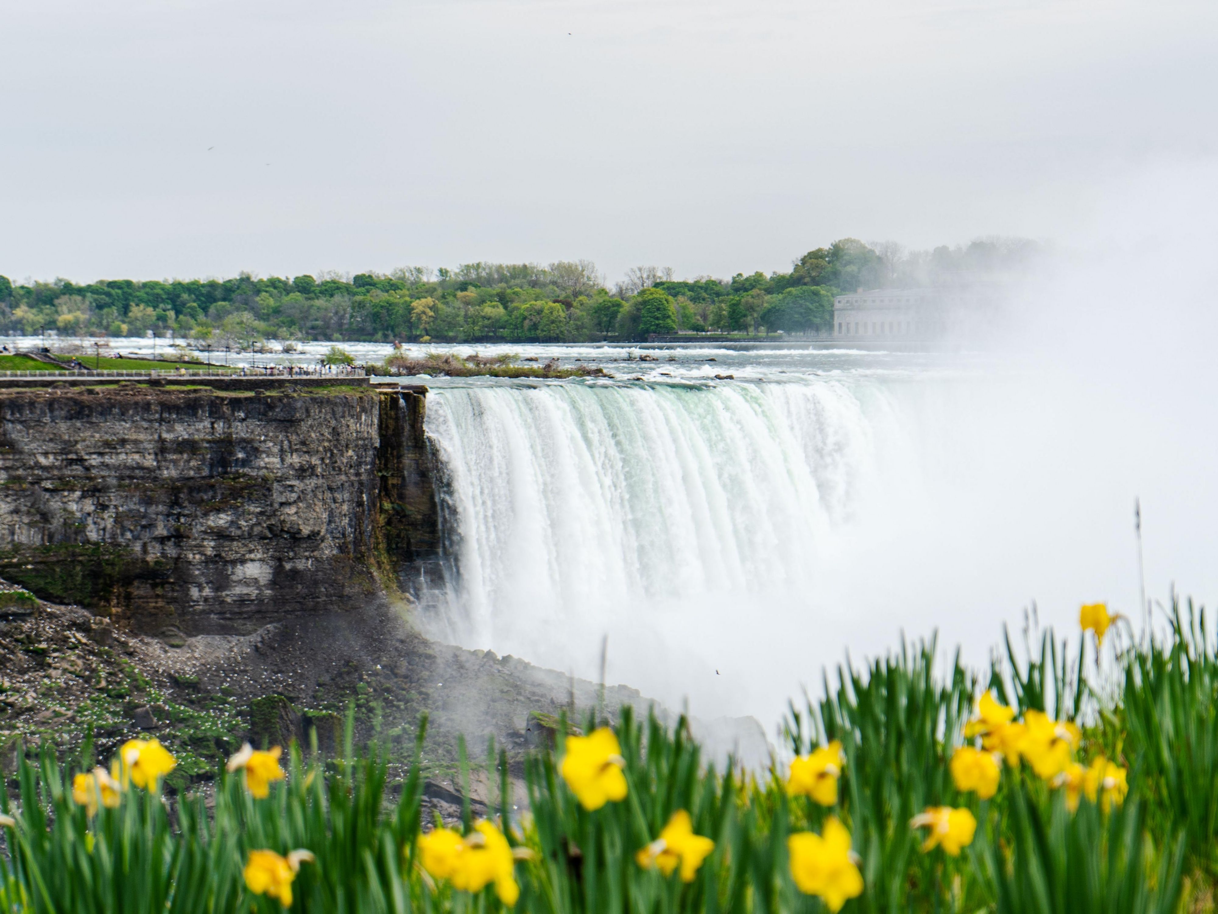 Niagara Park in Ontario offers sweeping, panoramic views of the full Horseshoe Falls, the most impressive and powerful part of the falls, and numerous restaurants, shops, hotels, and attractions like the Skylon Tower and casinos, catering to a lively tourist atmosphere.