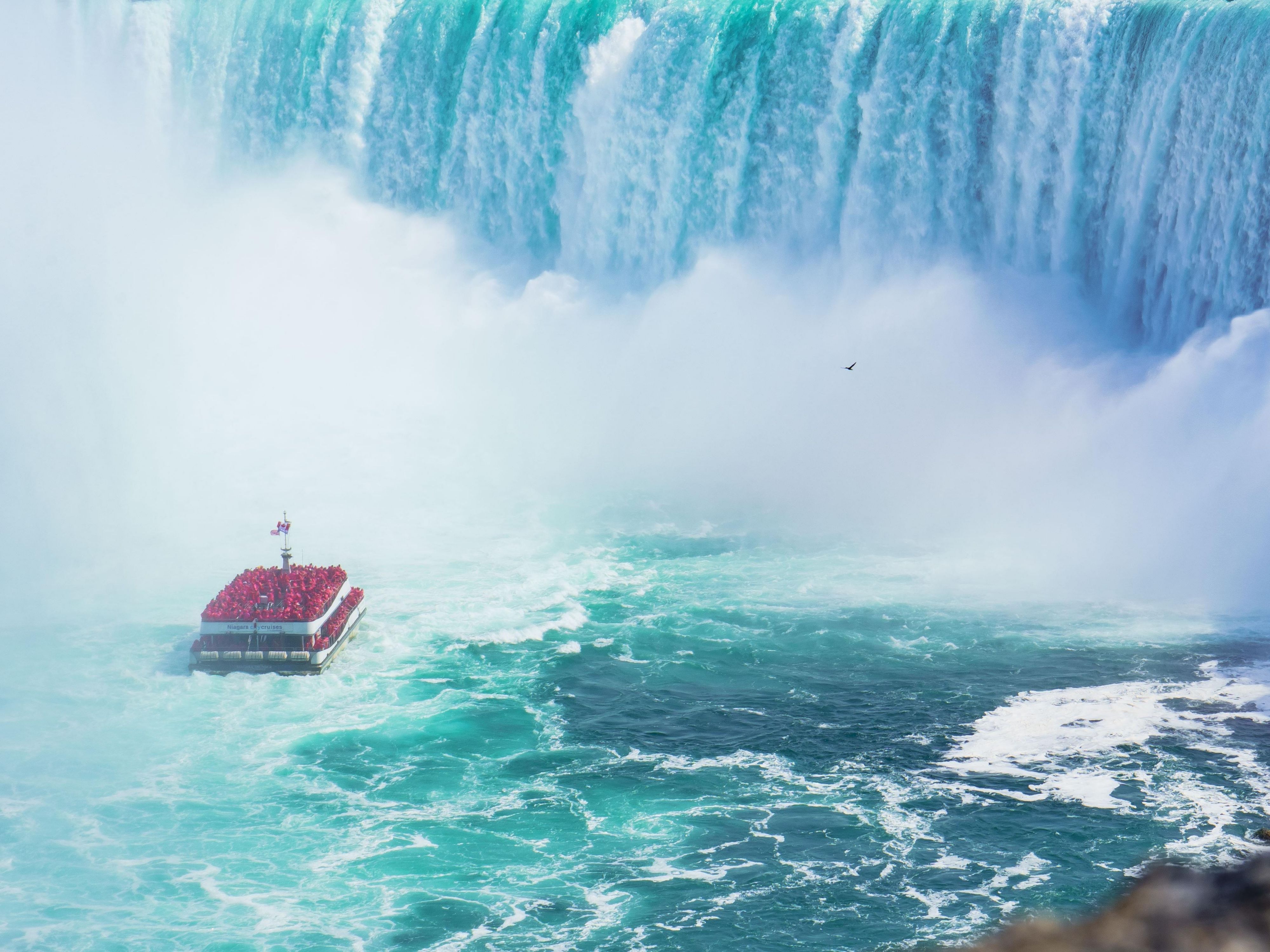 Cruise ship in the niagara falls water in the distance